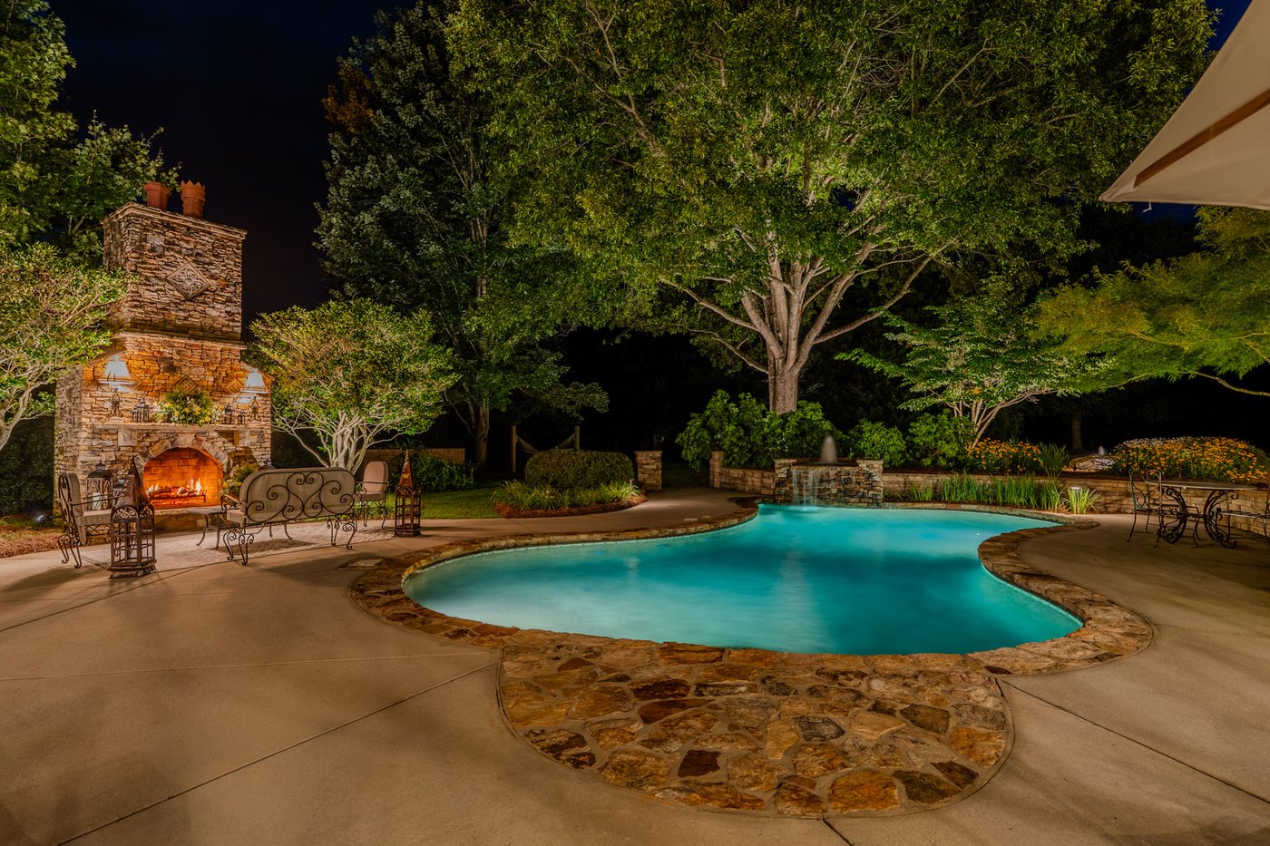 The outdoor fireplace lit after dark